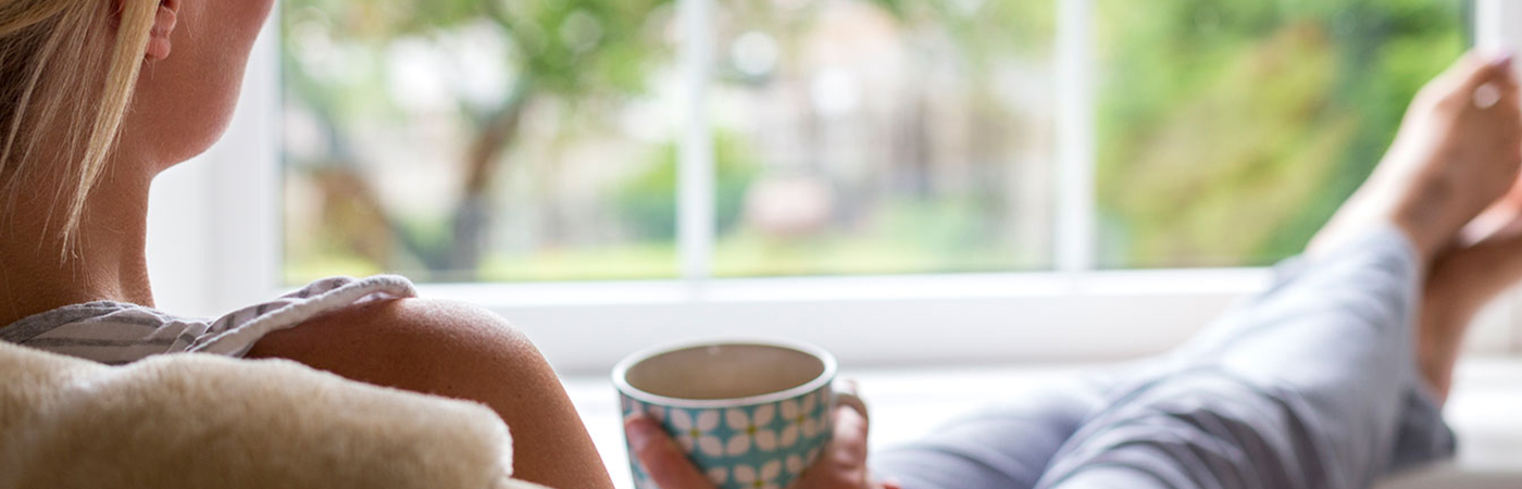 Someone sitting with their feet up having a cup of tea.